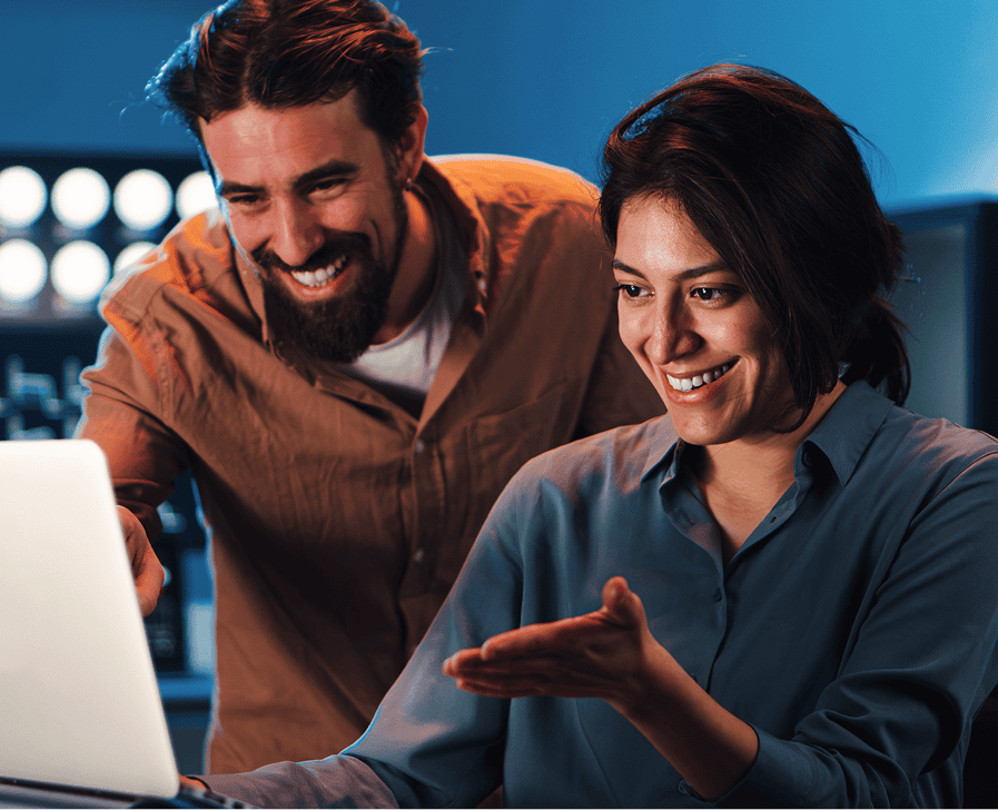 Two people discussing over a laptop.